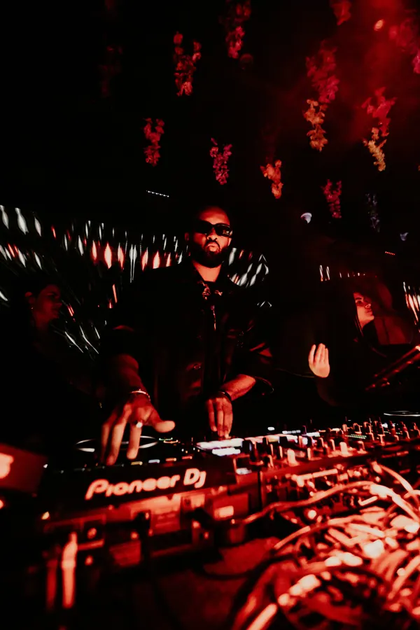 OKEMI on Pioneer DJ decks under red light